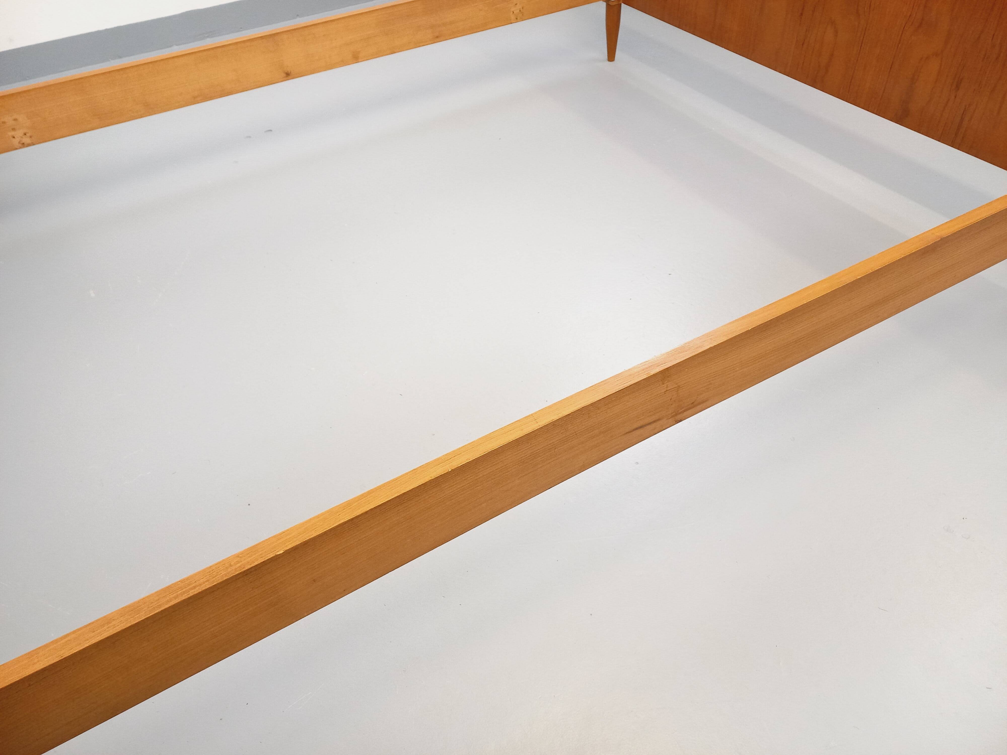 Double bed in vintage Scandinavian style from the 1960s with bedside tables.