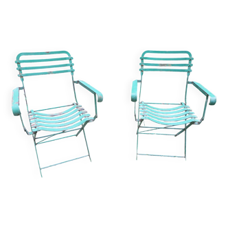Pair of distressed painted iron garden armchairs, 1920s