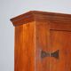 Vintage walnut wardrobe with exposed hardware.