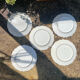 Antique plates from the late 19th century with scalloped edges and fruit decoration.