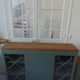 English sideboard, shallow, smoky green, wooden top.