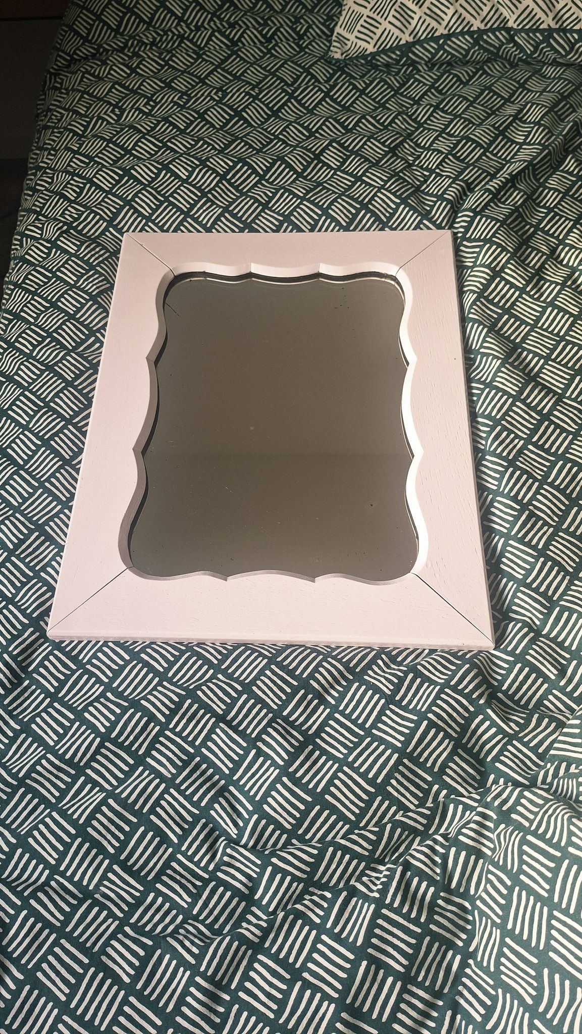 Mid-20th century rectangular wall mirror with a powder pink frame.