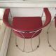 Pair of red chairs in 80s skai