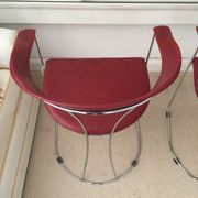 Pair of red chairs in 80s skai