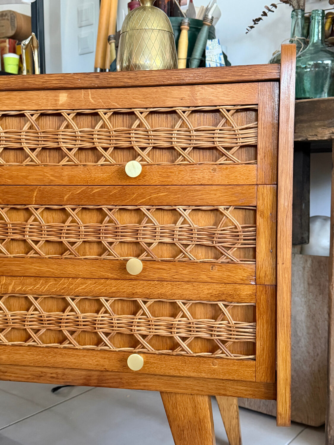 Vintage wooden and rattan chest of drawers with tapered legs.