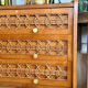 Vintage wooden and rattan chest of drawers with tapered legs.