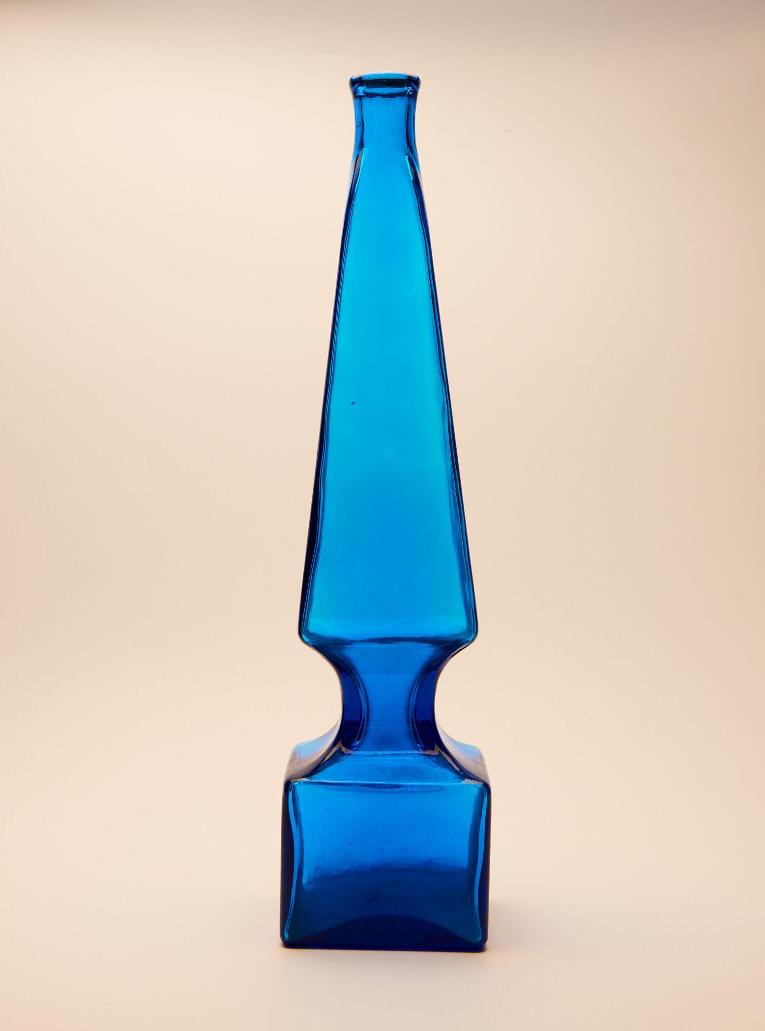 large blue glass obelisk-shaped bottle or vase
