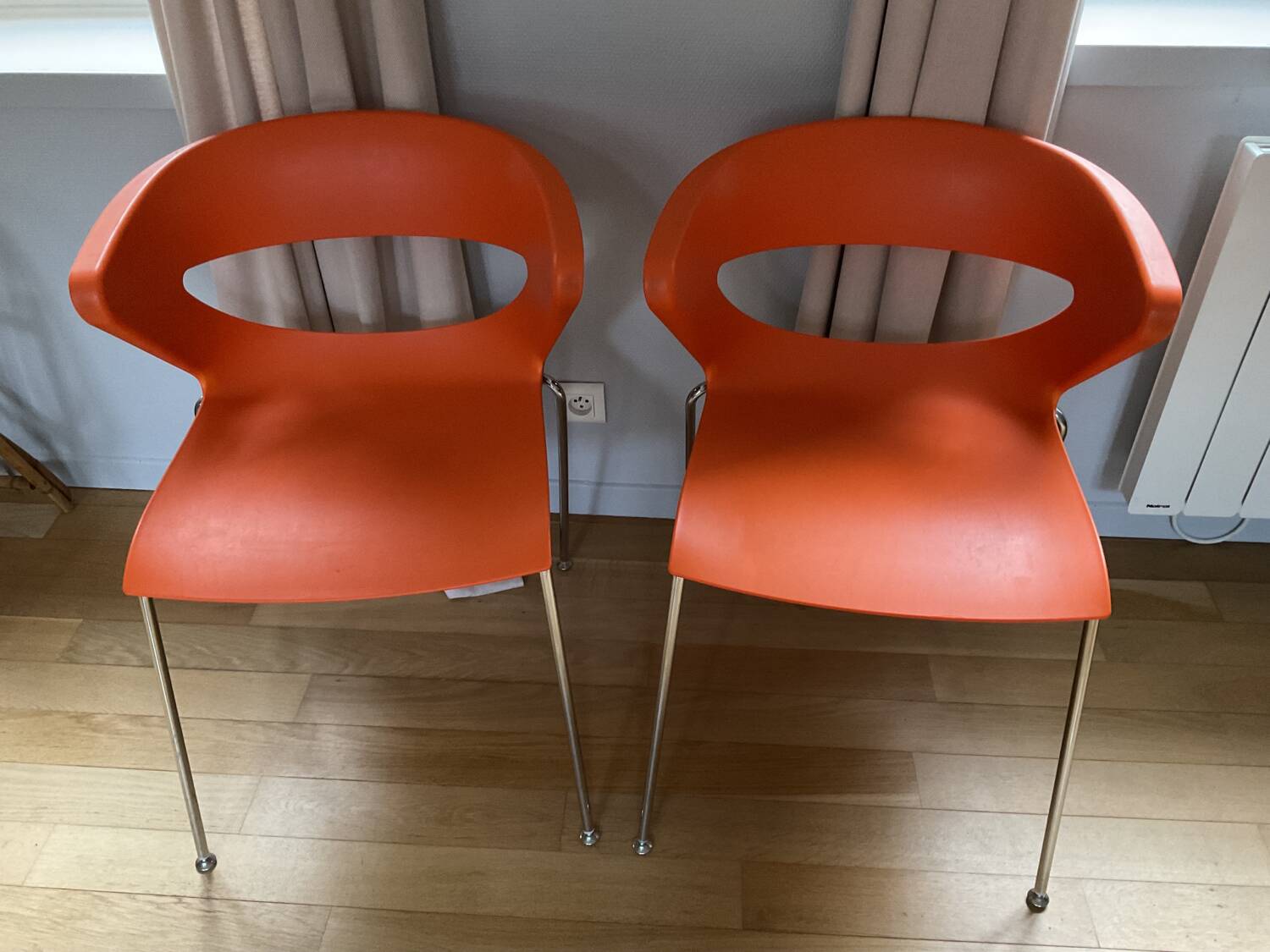 Two orange kicca chairs made in italy tbe
