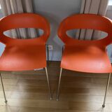 Two orange kicca chairs made in italy tbe