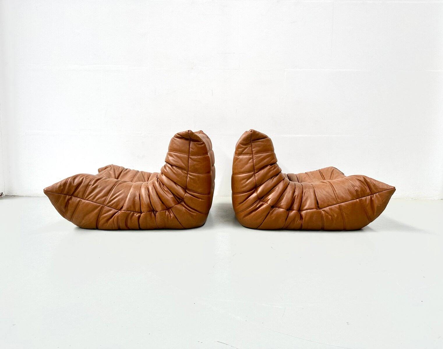 Togo lounge chairs in cognac cow leather attributed to Michel Ducaroy for Ligne Roset, set of 2