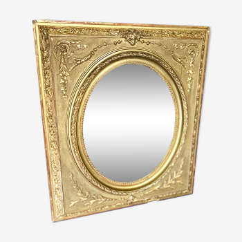 Mirror XIXth medallion on gilded frame with leaf