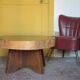 Brutalist wooden coffee table, cruciform leg with a tree trunk top.