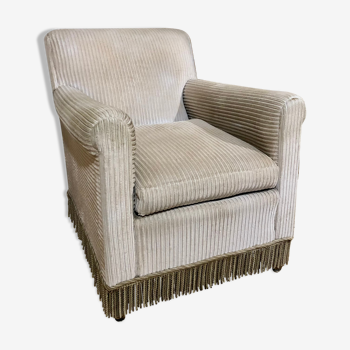 Velvet armchair with fringes