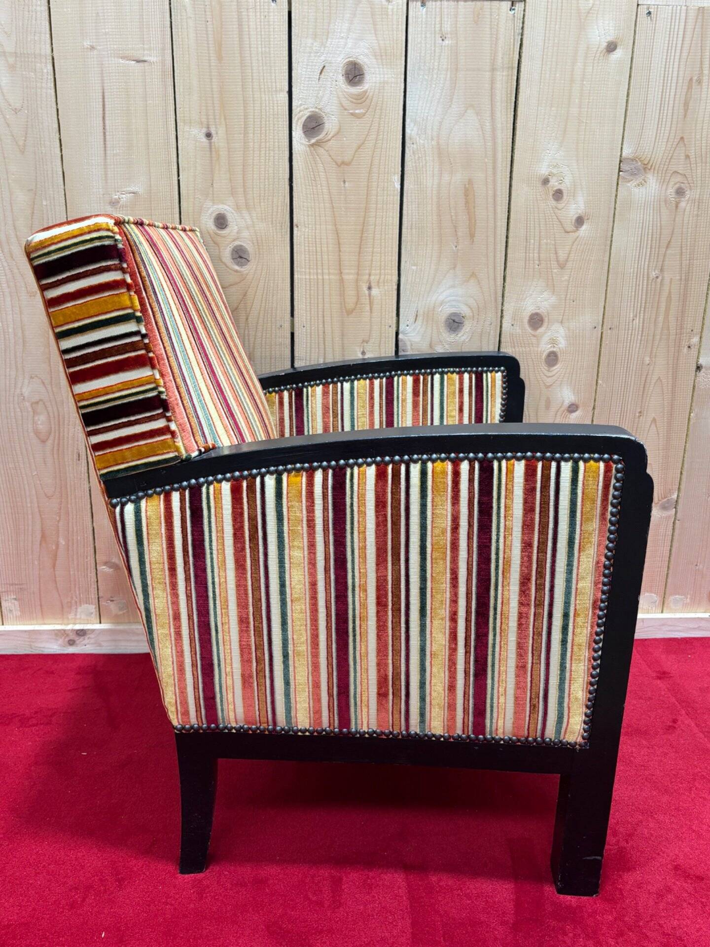 Art Deco armchair in multicolored striped fabric and its footrest
