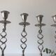 Four twisted silver candlesticks