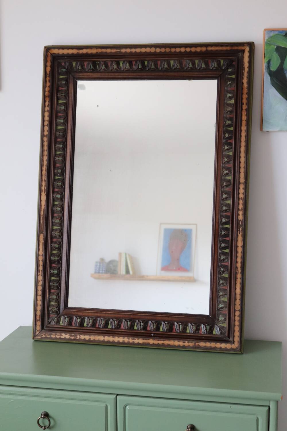 Antique mirror with a carved and painted wooden frame