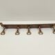 5 kitchen utensils and a brass wall mount