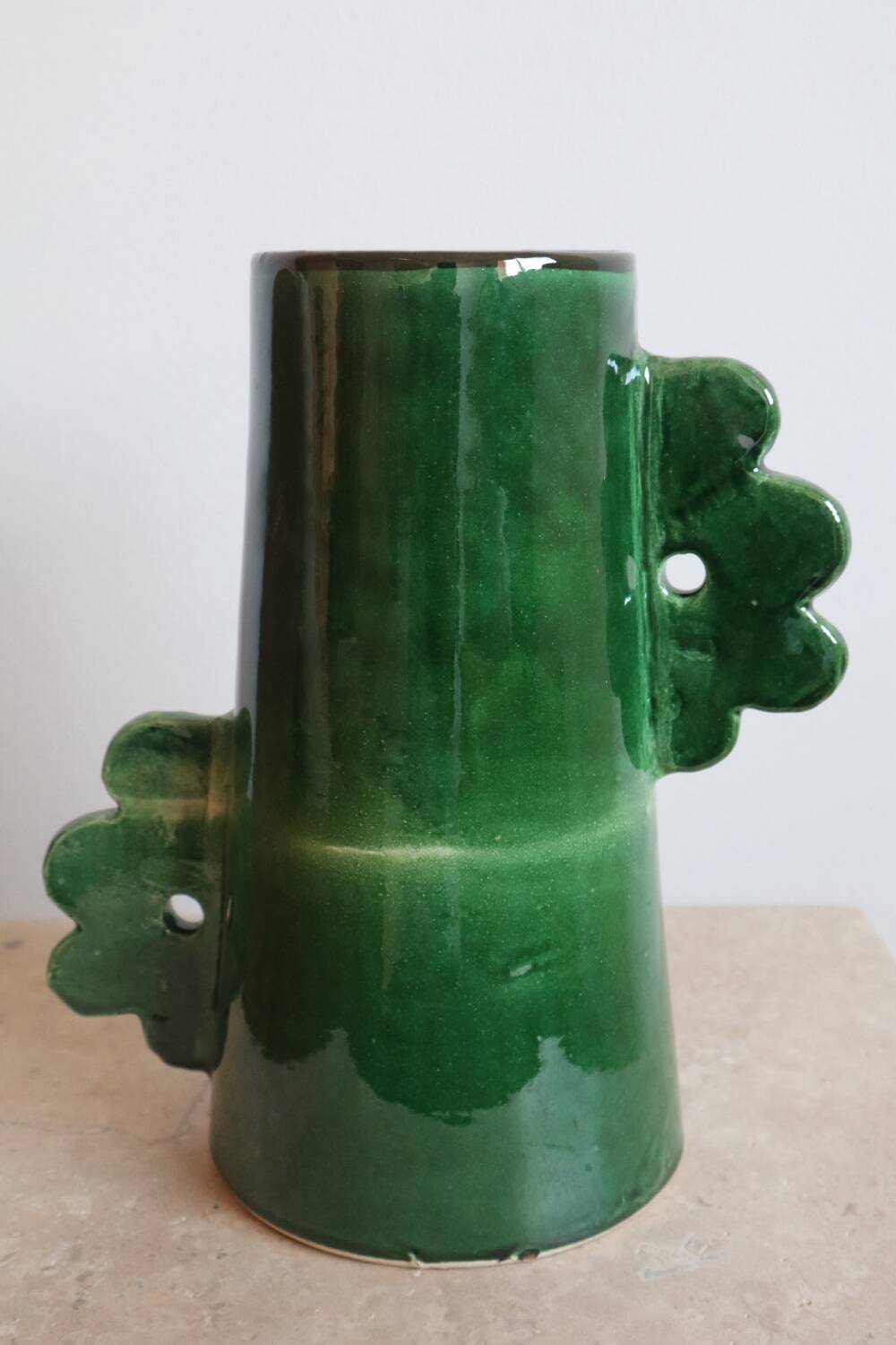 Handmade ceramic abstract vase with asymmetrical handles and fir green flowers
