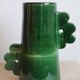 Handmade ceramic abstract vase with asymmetrical handles and fir green flowers