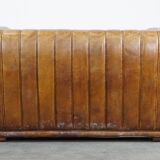 Cognac-colored cowhide 2-seater designer sofa finished with piping