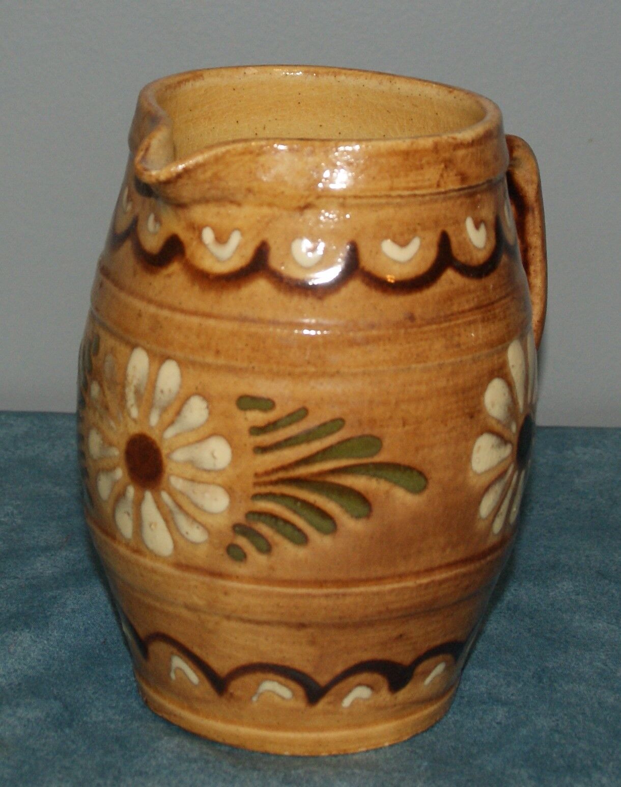 Glazed terracotta pitcher decorated with friezes and flowers