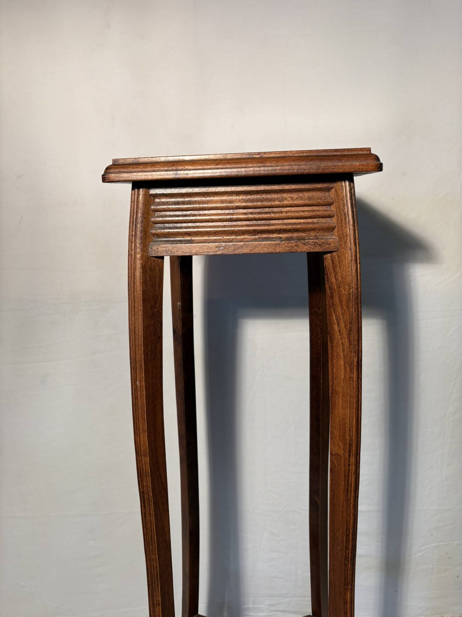 Vintage dark wood side table with curved base