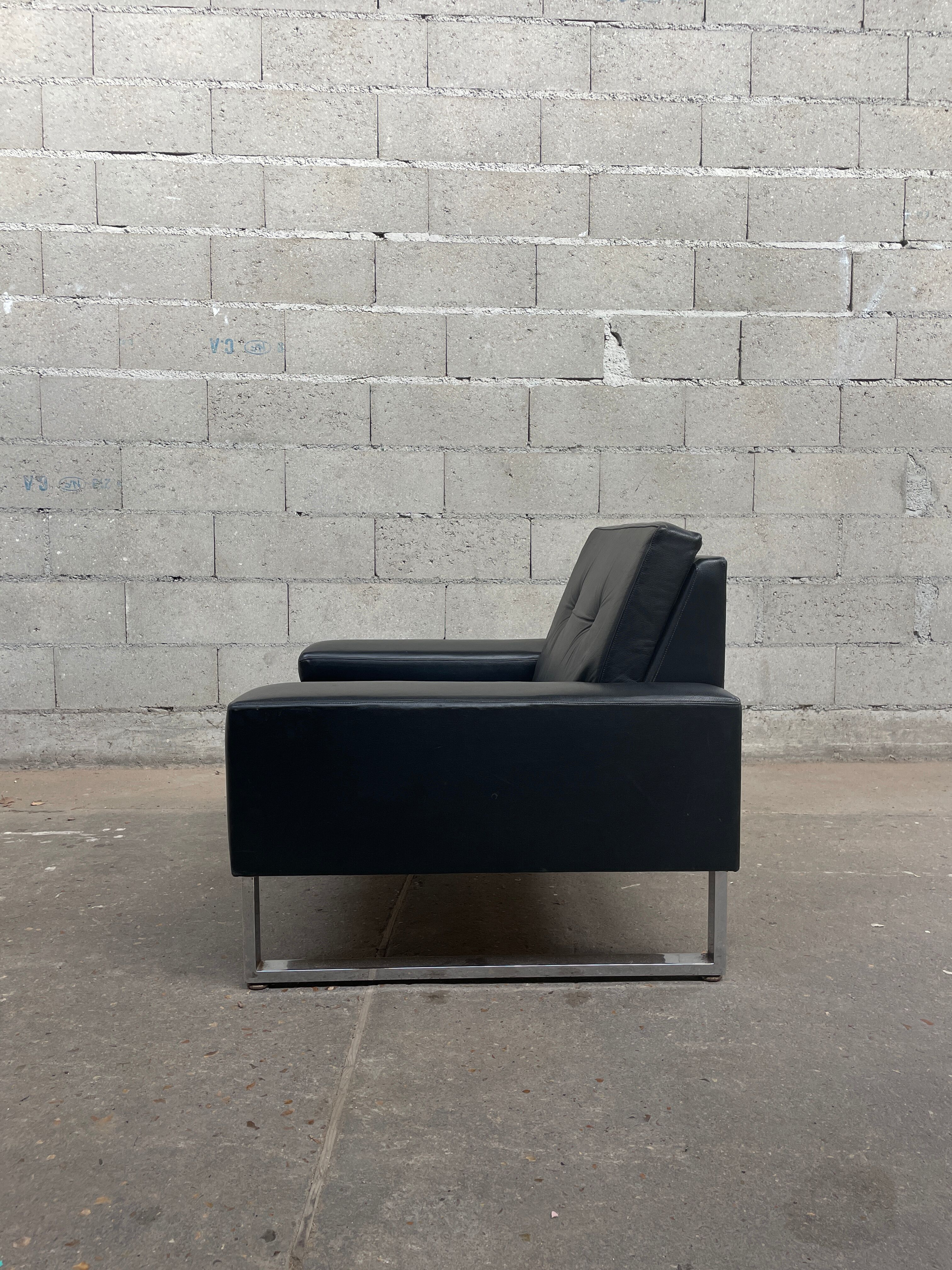 Pair of black leather armchairs