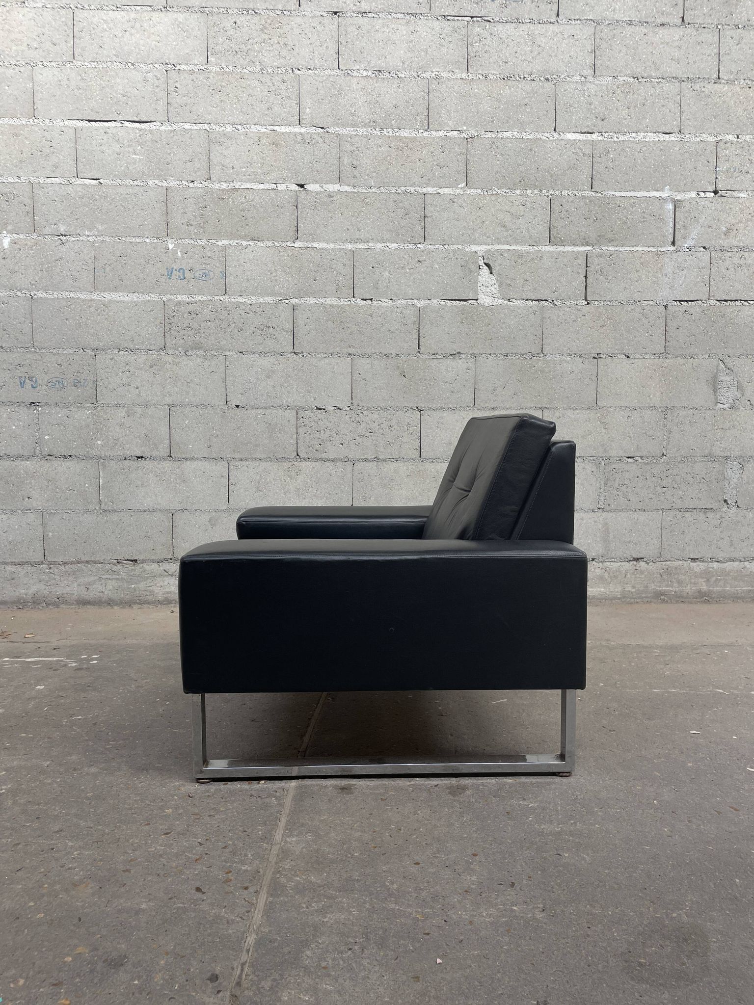 Pair of black leather armchairs