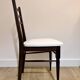Set of 5 wooden chairs with white faux leather.