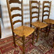 Set of 5 antique oak and straw chairs.