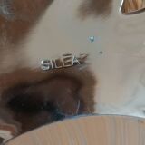 Silver-plated metal tray in the shape of a pineapple.