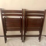 Pair of folding chairs in dark wooden slats