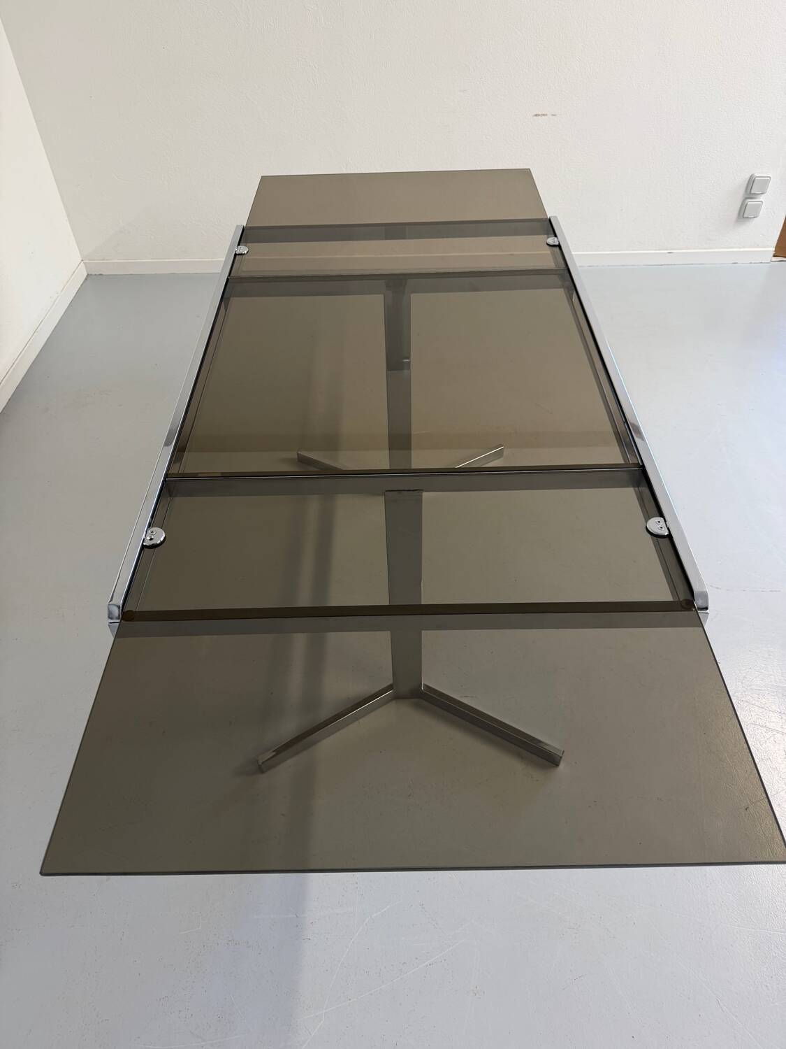 Smoked glass dining table with chrome legs, 1970s design by Roche Bobois.