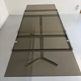 Smoked glass dining table with chrome legs, 1970s design by Roche Bobois.