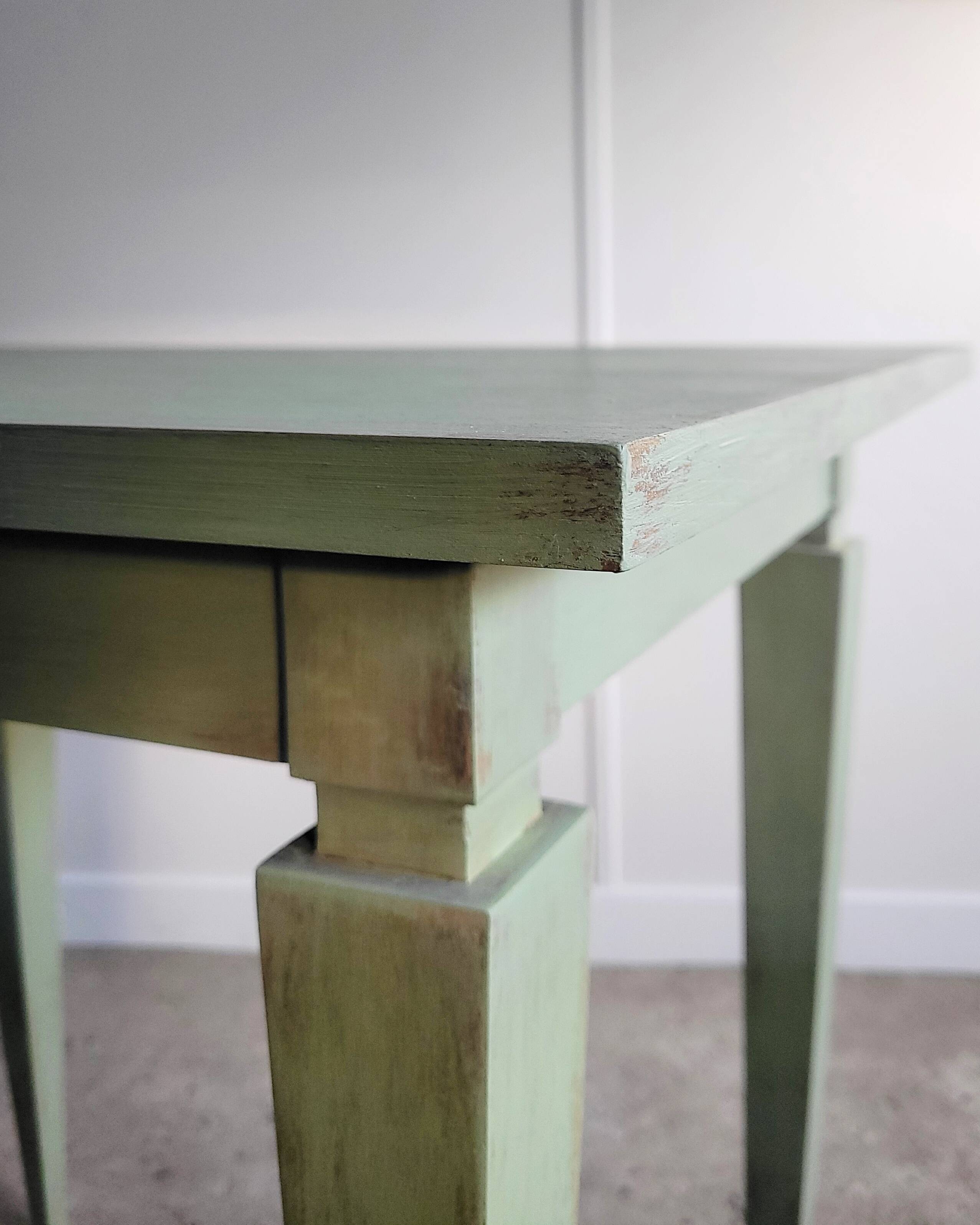 Green side table with tapered legs