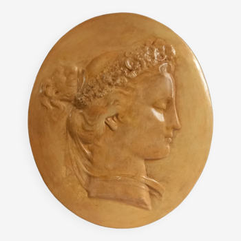 Plaster medallion, high relief, yellow ochre patina, representing the Roman agrarian deity Flora