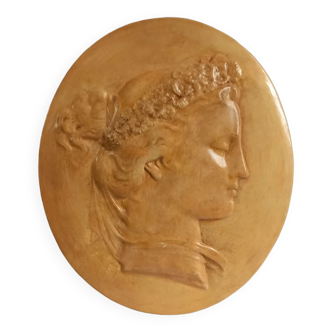 Plaster medallion, high relief, yellow ochre patina, representing the Roman agrarian deity Flora
