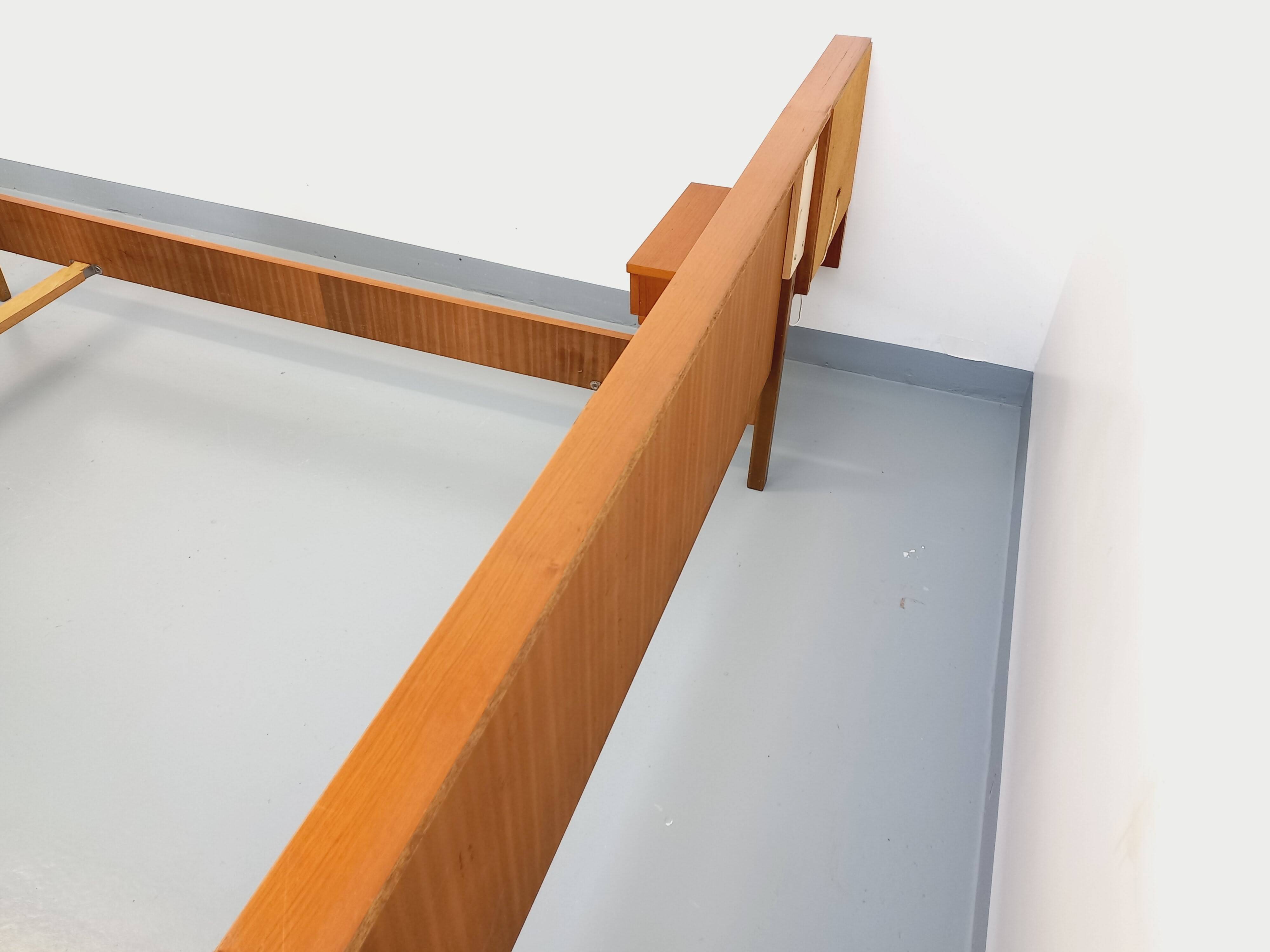 Vintage Scandinavian style double bed in teak from the 60s with integrated bedside lights