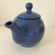 Vintage deep blue teapot, minimalist round shape.