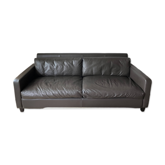 Brown leather three-seater sofa in excellent condition.