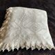 White cotton bedspread, crocheted sofa throw with star patterns