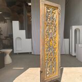 Rectangular Indonesian construction element with blue and yellow plant in carved wood