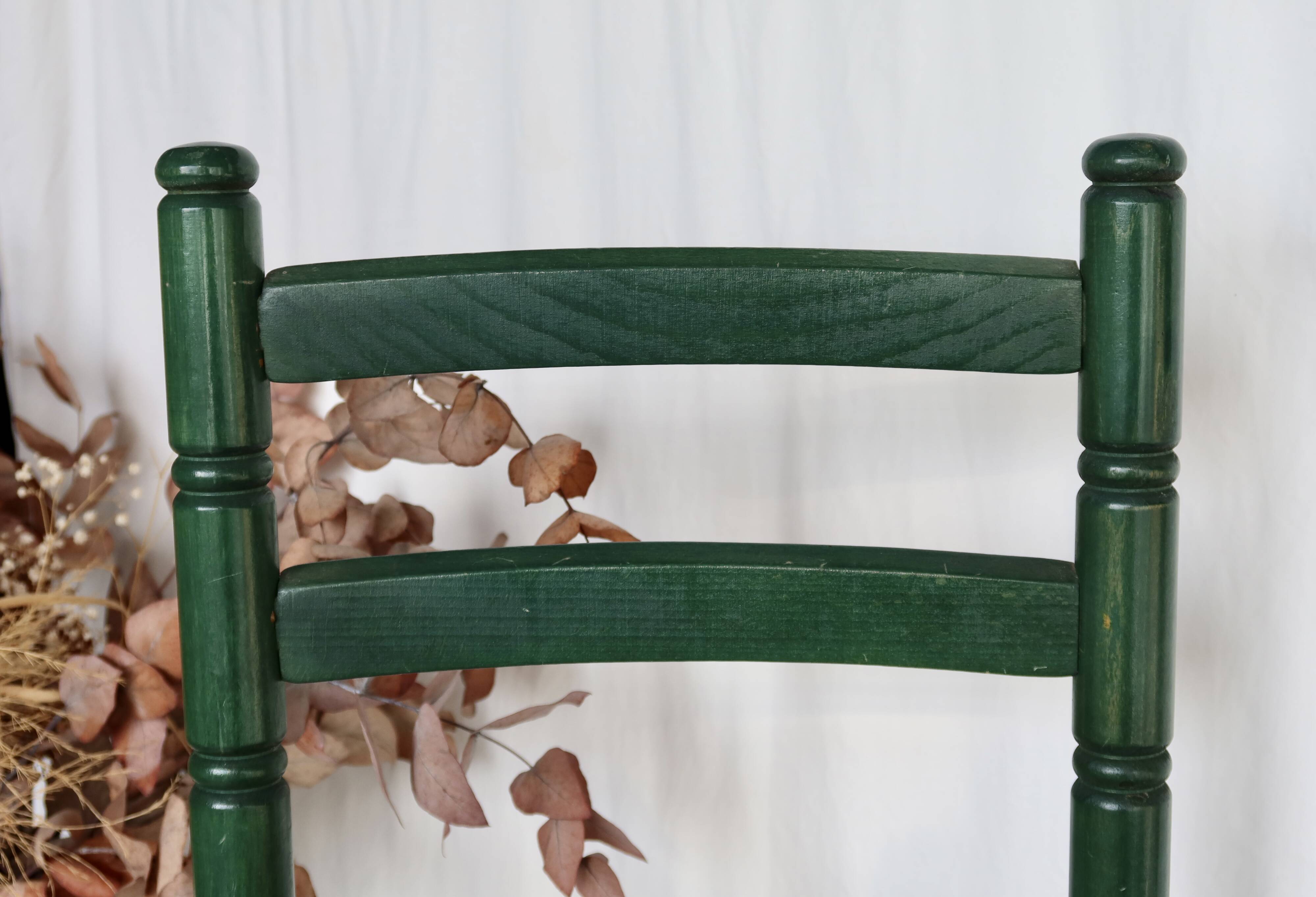 Vintage children's chair in green wood with a woven straw seat
