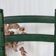 Vintage children's chair in green wood with a woven straw seat