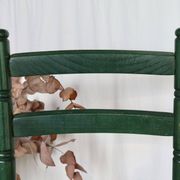 Vintage children's chair in green wood with a woven straw seat