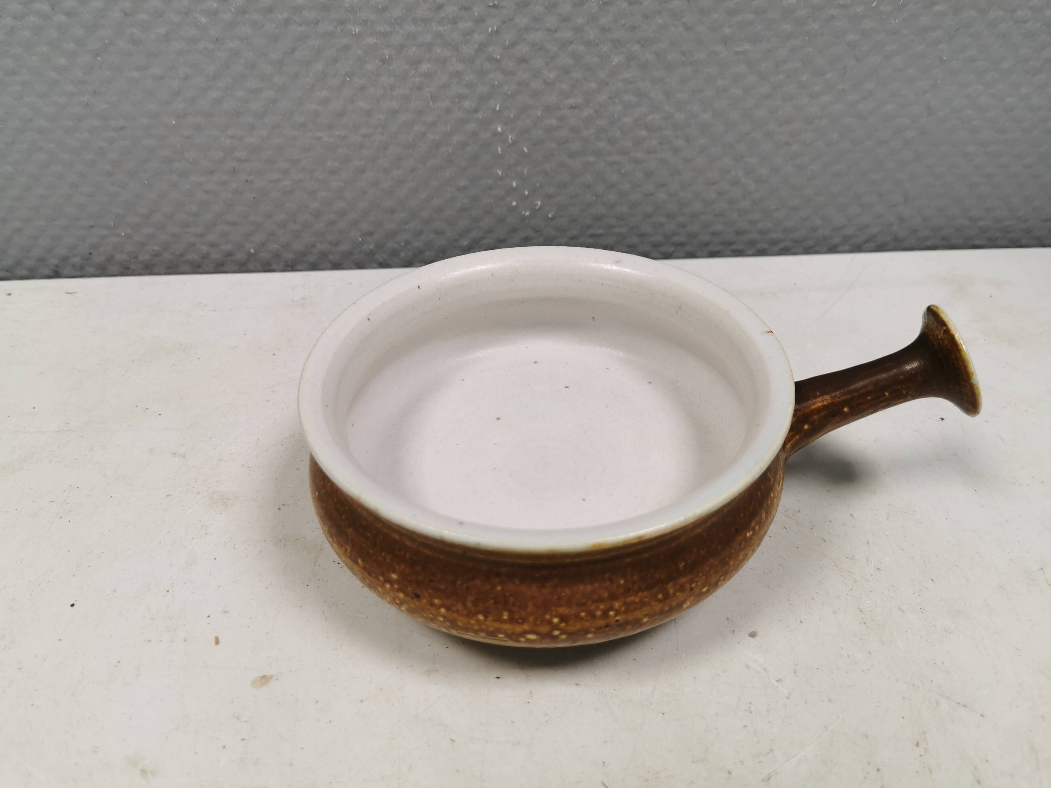 Small ceramic bowl with handle, in golden colours. Danish 1960-70s
