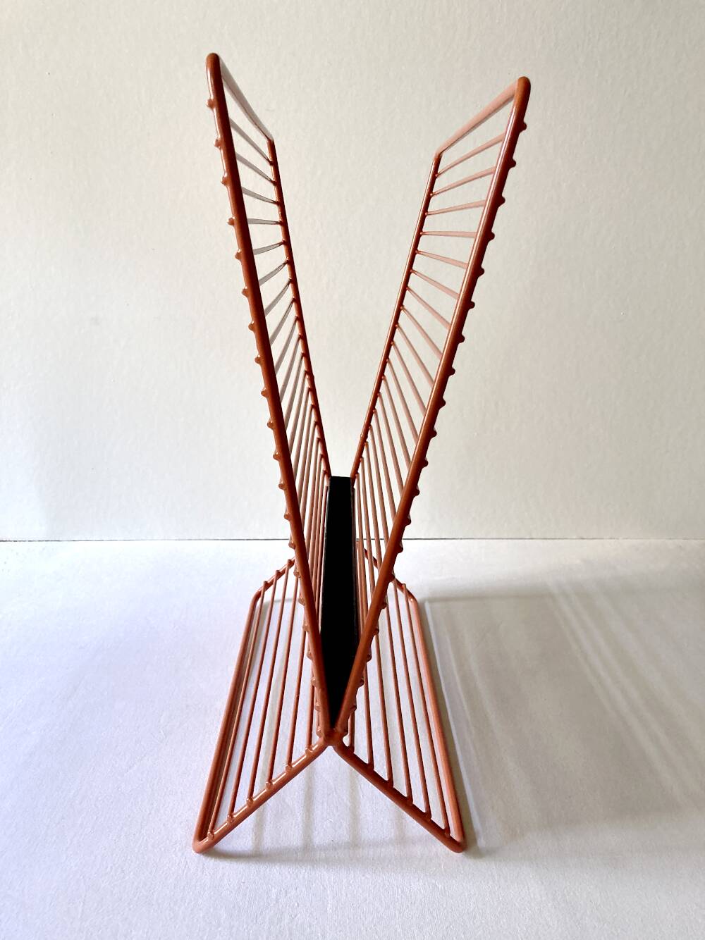 Wire metal magazine rack with triangular compartment, 1950s.