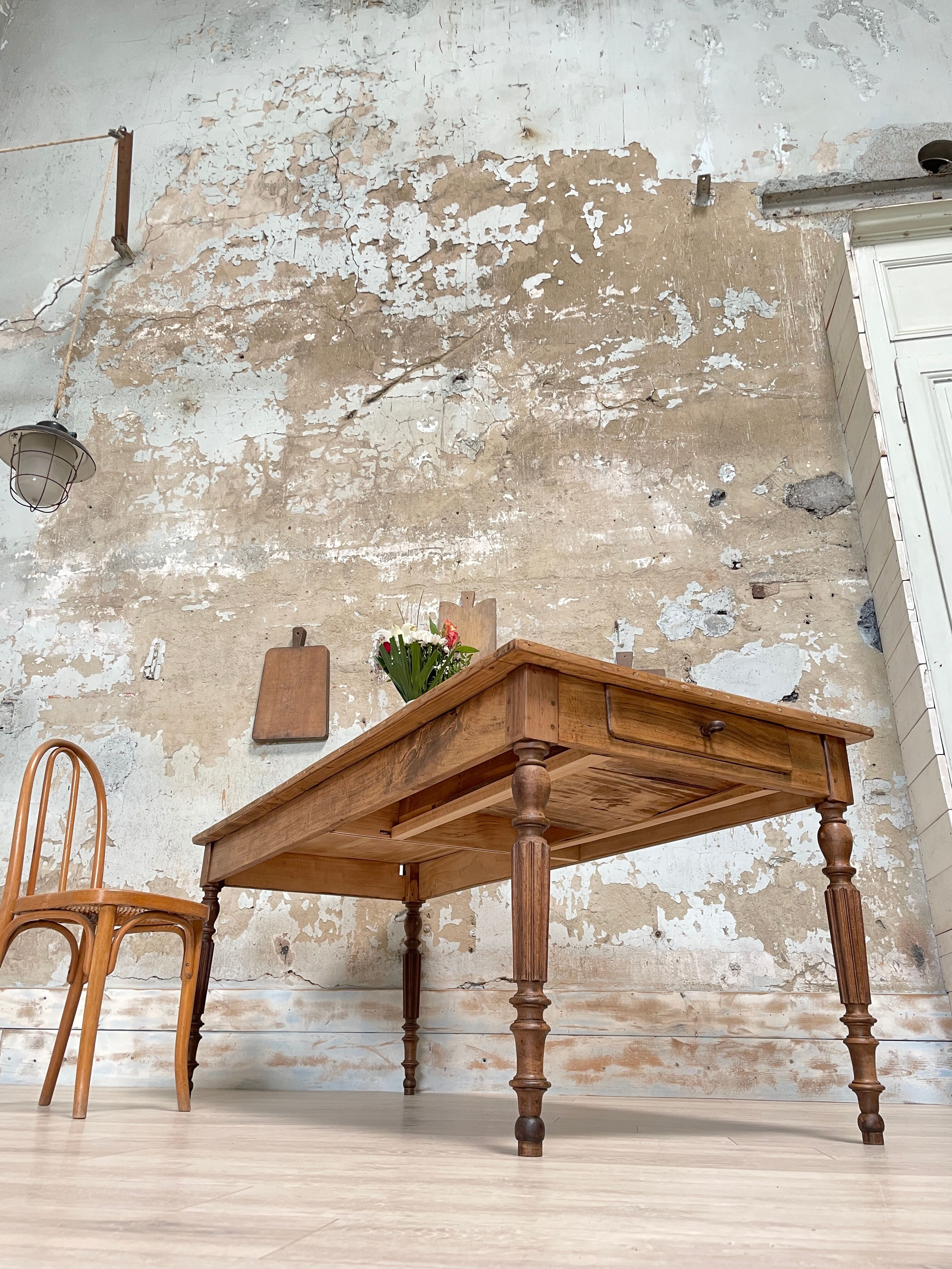 Vintage farmhouse table with turned legs.