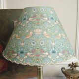 Brass candlestick lamp with its fabric lampshade by William Morris