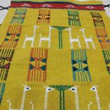 Mustard colored carpet with gazelle patterns berber style
